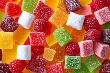 A vibrant assortment of freeze-dried candies including fruits, marshmallows, and candy bars, showcasing diverse textures and rich colors, reflecting creativity in homemade candy-making.