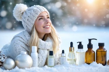 A woman embracing winter with a radiant complexion, surrounded by skincare products in a snowy landscape.