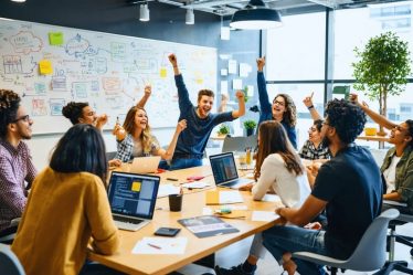 Young entrepreneurs at Yale collaborating in a creative workspace, symbolizing the innovative spirit fostered by the Yale Entrepreneurship Society.