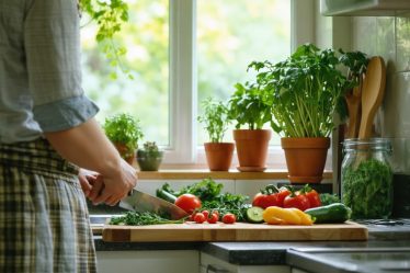 A person mindfully chopping fresh vegetables in a peaceful, well-lit kitchen surrounded by herbs and rustic kitchenware.