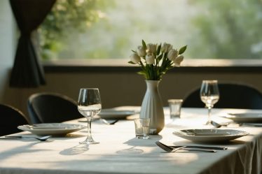 A serene dining space with a single elegant plate setting, soft natural lighting, and a calming table arrangement, exemplifying a mindful eating environment.