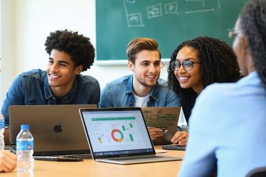 Diverse group of students collaborating in a business simulation exercise with a mentor, using laptops and digital tools in a modern classroom setting.