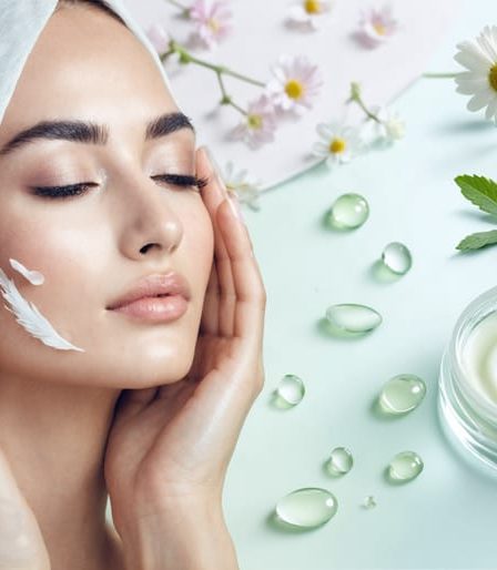 A serene face being cared for with gentle touches and enveloped in a silk cloth, surrounded by illustrations of soothing ingredients like aloe vera and chamomile against a pastel background, representing a nurturing skincare routine for sensitive skin.