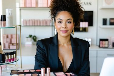 Professional female beauty entrepreneur analyzing product samples and strategic branding plans, symbolizing the transformation of a beauty business into a brand empire.