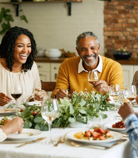 A multi-generational family engaging in conversation around a dinner table, enjoying a meal together without electronic devices, illustrating the theme of strengthening family bonds through improved communication.