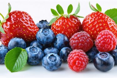 A visually appealing assortment of fresh blueberries, strawberries, raspberries, and blackberries, showcasing their vibrant colors and natural sheen on a clean white background.