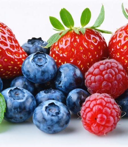 A visually appealing assortment of fresh blueberries, strawberries, raspberries, and blackberries, showcasing their vibrant colors and natural sheen on a clean white background.