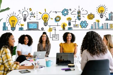 Group of diverse women entrepreneurs exchanging ideas in a vibrant coworking space, symbolizing innovation and empowerment in entrepreneurship.