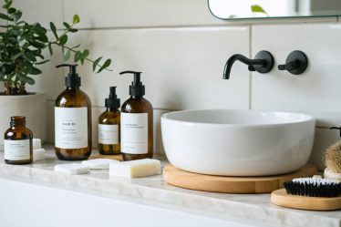 A minimalist bathroom counter displaying zero waste beauty products including solid shampoo bars, reusable cotton pads, and bottles of natural oils in a serene and eco-friendly setting.