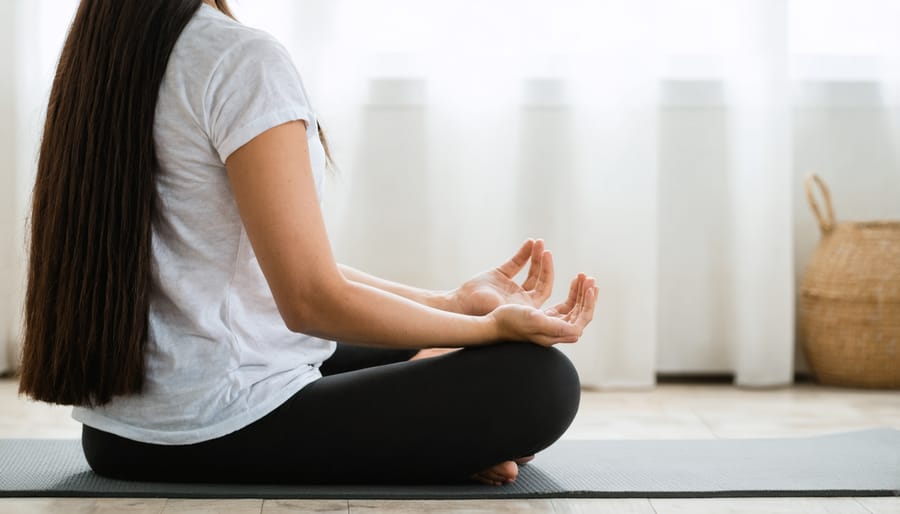 Individual practicing budget-friendly stress relief activities at home